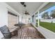 Enclosed patio has a view of the backyard, with ceiling fans, outdoor carpet, and furniture at 1756 Elinor Pl, Englewood, FL 34223