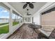 Enclosed patio with ceiling fans, outdoor carpet and furniture at 1756 Elinor Pl, Englewood, FL 34223