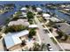 Waterfront home with an updated metal roof and lush landscaping along the canal at 187 Beeney Se Rd, Port Charlotte, FL 33952
