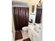Cozy bathroom featuring a shower/tub combo, single sink vanity and neutral color palette at 187 Beeney Se Rd, Port Charlotte, FL 33952