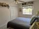 Comfortable bedroom featuring a calming blue color palette, closet, and natural light at 187 Beeney Se Rd, Port Charlotte, FL 33952