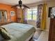 Colorful bedroom featuring a comfortable bed, ceiling fan, and ample natural light, creating a cozy retreat at 187 Beeney Se Rd, Port Charlotte, FL 33952
