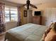 Relaxing bedroom view with a large window, water view, and a tropical ceiling fan at 187 Beeney Se Rd, Port Charlotte, FL 33952