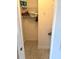 Walk-in closet providing storage space with shelves, hangers and neutral flooring at 187 Beeney Se Rd, Port Charlotte, FL 33952