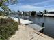Wooden dock featuring a boat lift, perfect for waterfront living and boating at 187 Beeney Se Rd, Port Charlotte, FL 33952