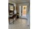 Inviting foyer with decorative glass door and stylish console table with mirror, perfect for welcoming guests at 187 Beeney Se Rd, Port Charlotte, FL 33952