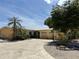 Inviting single-story home boasting a lush landscaped yard, a two-car garage, and a charming covered entry at 187 Beeney Se Rd, Port Charlotte, FL 33952