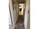 Hallway featuring a decorative rug, light colored walls and a bright interior view at 187 Beeney Se Rd, Port Charlotte, FL 33952