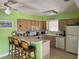 Bright kitchen features a breakfast bar with seating and an open layout at 187 Beeney Se Rd, Port Charlotte, FL 33952