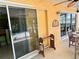 Exterior view of lanai showing sliding glass door and decorative elements, creating a charming outdoor space at 187 Beeney Se Rd, Port Charlotte, FL 33952