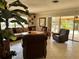 Bright living room featuring a large sectional sofa, recliner, and sliding glass doors to the lanai at 187 Beeney Se Rd, Port Charlotte, FL 33952