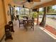 Relaxing screened-in patio features ceiling fans, waterfront views and tiled floors, ideal for outdoor dining and entertainment at 187 Beeney Se Rd, Port Charlotte, FL 33952