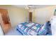 Inviting bedroom featuring neutral walls, a built-in closet, and a convenient en-suite bathroom for added privacy at 18954 Ayrshire Cir, Port Charlotte, FL 33948