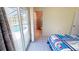Bright bedroom featuring sliding glass doors to pool and ensuite bath at 18954 Ayrshire Cir, Port Charlotte, FL 33948