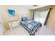 Comfortable bedroom with tiled floors, natural light, a dresser, and access to the outdoor screened lanai at 18954 Ayrshire Cir, Port Charlotte, FL 33948
