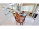 Cozy kitchen and dining area with white cabinets, tile floors, and a dining table ideal for casual meals and Gathering gatherings at 18954 Ayrshire Cir, Port Charlotte, FL 33948