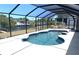 Beautiful screened-in pool overlooking the canal and neighborhood landscape at 18954 Ayrshire Cir, Port Charlotte, FL 33948