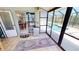 Bright sunroom with tile flooring, sliding glass doors, and view of the pool and canal at 18954 Ayrshire Cir, Port Charlotte, FL 33948