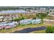 An aerial view shows colorful condo buildings next to a serene lake and convenient covered parking spaces at 2020 Willow Hammock Cir # 302, Punta Gorda, FL 33983