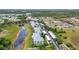 An aerial view shows colorful condo buildings next to a serene lake and convenient covered parking spaces at 2020 Willow Hammock Cir # 302, Punta Gorda, FL 33983