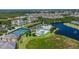 Overhead view showcasing the community's pool, clubhouse, tennis courts, lake, and colorful residential buildings at 2020 Willow Hammock Cir # 302, Punta Gorda, FL 33983