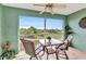 Inviting screened balcony with table, seating, and serene water views, perfect for relaxation at 2020 Willow Hammock Cir # 302, Punta Gorda, FL 33983