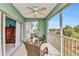 Charming screened balcony with fan, glass-top table, peaceful setting, and water views at 2020 Willow Hammock Cir # 302, Punta Gorda, FL 33983