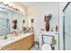 Bright bathroom with dual sinks, vanity, large mirror and stall shower at 2020 Willow Hammock Cir # 302, Punta Gorda, FL 33983
