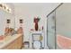 Bathroom includes dual sink vanity, mirror, decor, and walk-in shower at 2020 Willow Hammock Cir # 302, Punta Gorda, FL 33983