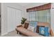 Cozy bedroom with comfortable futon, stylish pillows, and a view from the window at 2020 Willow Hammock Cir # 302, Punta Gorda, FL 33983