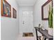 Light and bright foyer with tasteful decorations and tile flooring leading into the unit at 2020 Willow Hammock Cir # 302, Punta Gorda, FL 33983