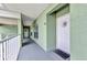 Hallway leading to unit 302 with stylish front door embellishments and a welcome mat at 2020 Willow Hammock Cir # 302, Punta Gorda, FL 33983