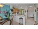 Bright condo living room shows breakfast bar overlooking kitchen and tiled foyer at 2020 Willow Hammock Cir # 302, Punta Gorda, FL 33983