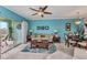 Cozy living room features modern ceiling fan, comfortable seating, and natural light from the sliding glass doors at 2020 Willow Hammock Cir # 302, Punta Gorda, FL 33983