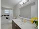 Bright bathroom featuring a vanity with drawers, a white countertop, and a bathtub with a shower at 20215 Macon Ln, Port Charlotte, FL 33952