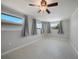 Bright bedroom with neutral walls, tile flooring, and windows with gray curtains for natural light at 20215 Macon Ln, Port Charlotte, FL 33952