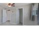 The bedroom features tile floors, neutral paint and trim, and a ceiling fan at 20215 Macon Ln, Port Charlotte, FL 33952