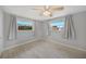 Bedroom featuring tile flooring and large windows covered by gray curtains for ample natural light at 20215 Macon Ln, Port Charlotte, FL 33952