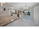Bright eat-in kitchen with granite countertops, stainless appliances and open layout to outdoor patio at 20215 Macon Ln, Port Charlotte, FL 33952