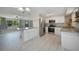 Open concept kitchen with white cabinetry, stainless appliances, and granite countertops at 20215 Macon Ln, Port Charlotte, FL 33952