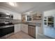 Updated kitchen featuring stainless steel appliances, white cabinets, granite countertops, and tile flooring at 20215 Macon Ln, Port Charlotte, FL 33952