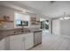 Bright kitchen with granite countertops, stainless steel appliances, and sliding glass doors to the lanai at 20215 Macon Ln, Port Charlotte, FL 33952