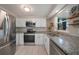 Modern kitchen features stainless steel appliances, granite countertops, and white cabinets at 20215 Macon Ln, Port Charlotte, FL 33952