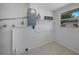 Laundry room featuring tile flooring, a small window, and shelving to hold wash supplies at 20215 Macon Ln, Port Charlotte, FL 33952
