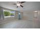 Bright living room featuring light tile flooring, neutral walls, and large window at 20215 Macon Ln, Port Charlotte, FL 33952