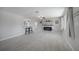 Bright living room open to the kitchen with gray tile floors, modern lighting, and electric fireplace at 20215 Macon Ln, Port Charlotte, FL 33952