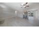 Living room with gray tile flooring, breakfast bar, and an open layout that connects to the kitchen at 20215 Macon Ln, Port Charlotte, FL 33952
