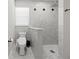 Modern bathroom with mosaic flooring in the glass-enclosed shower and a comfort-height toilet at 2186 Florala St, North Port, FL 34287