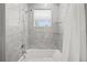 Bathroom with a stone shower, glass shelving, and a window with blinds at 2186 Florala St, North Port, FL 34287