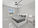 Inviting bedroom with a large window, ceiling fan, and neutral decor at 2186 Florala St, North Port, FL 34287